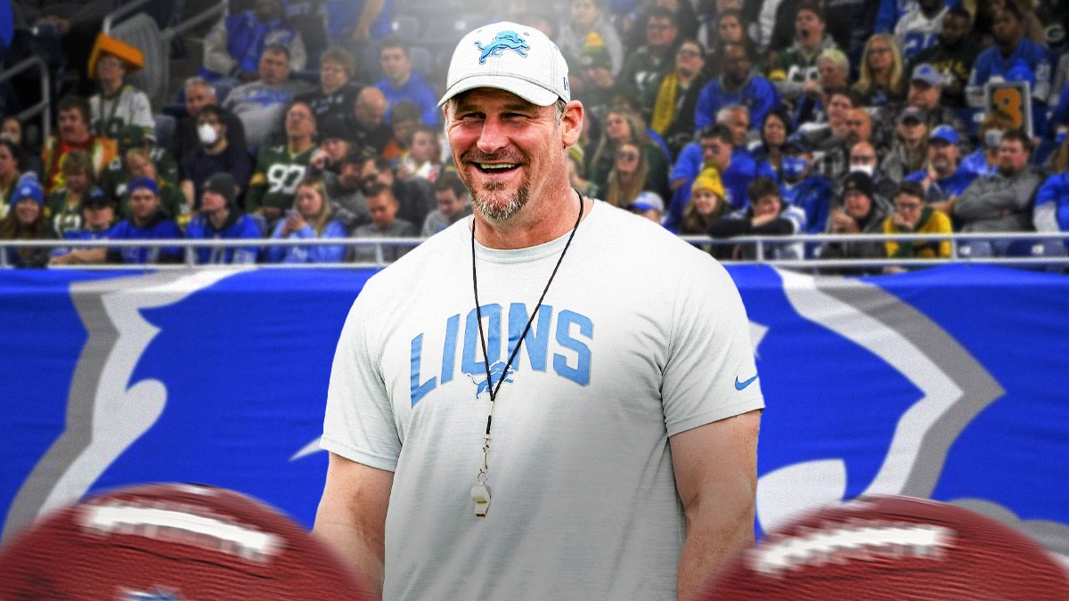 Dan Campbell smiles in Lions gear