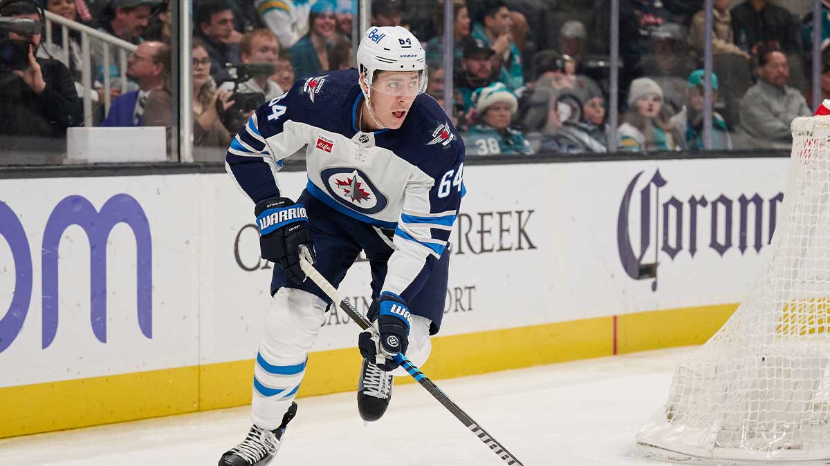 Winnipeg Jets defenseman Logan Stanley (64) skates with the puck against the San Jose Sharks during the second period at SAP Center at San Jose.