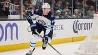 Winnipeg Jets defenseman Logan Stanley (64) skates with the puck against the San Jose Sharks during the second period at SAP Center at San Jose.