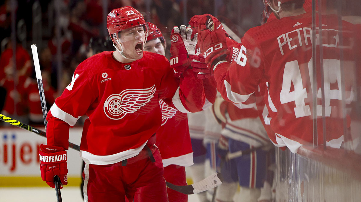 Detroit Red Wings left wing Lucas Raymond (23) receives congratulations from teammates after scoring in the third period against the Montreal Canadiens at Little Caesars Arena.