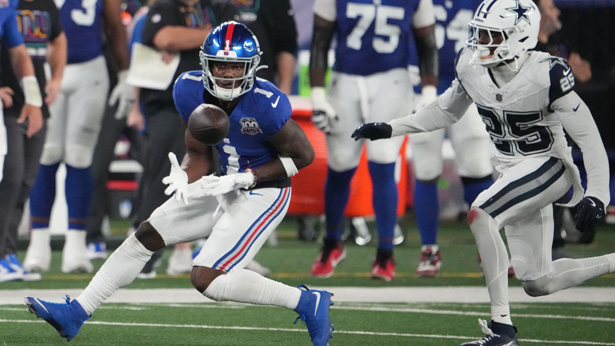 New York Giants wide receiver Malik Nabers (1) gathers in a pass in front of Dallas Cowboys cornerback Andrew Booth Jr. (25) in the first half at MetLife Stadium.