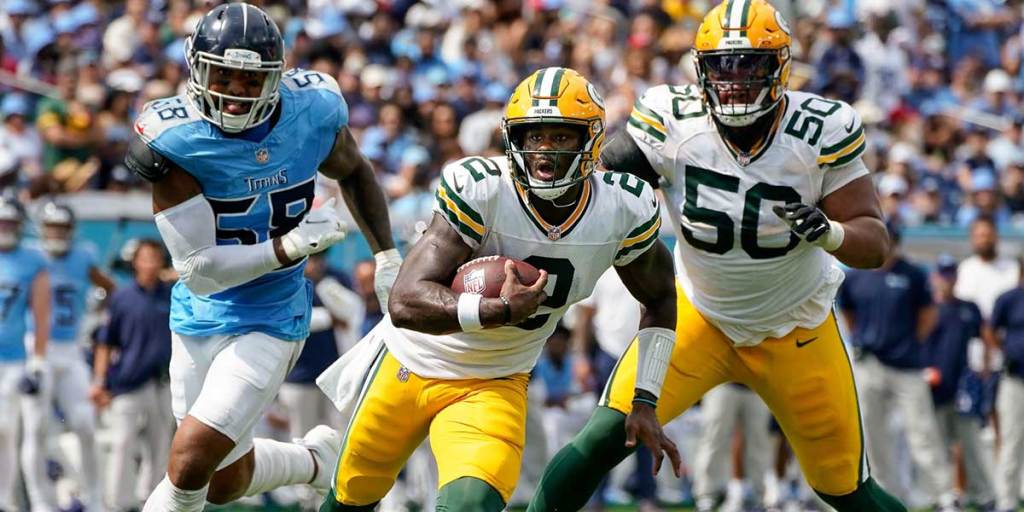 Green Bay Packers quarterback Malik Willis (2) runs the ball past Tennessee Titans linebacker Harold Landry III (58) during the second quarter at Nissan Stadium in Nashville, Tenn.