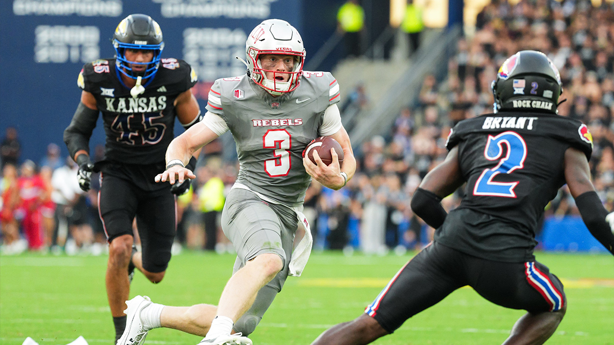 UNLV Rebels quarterback Matthew Sluka (3) runs the ball against Kansas Jayhawks defensive end Dean Miller (45) and cornerback Cobee Bryant (2) during the first half at Children's Mercy Park.