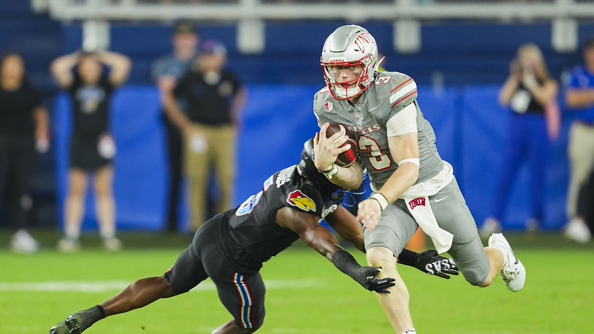 UNLV Rebels quarterback Matthew Sluka (3) runs the ball against Kansas Jayhawks safety O.J. Burroughs (5) during the second half at Children's Mercy Park.