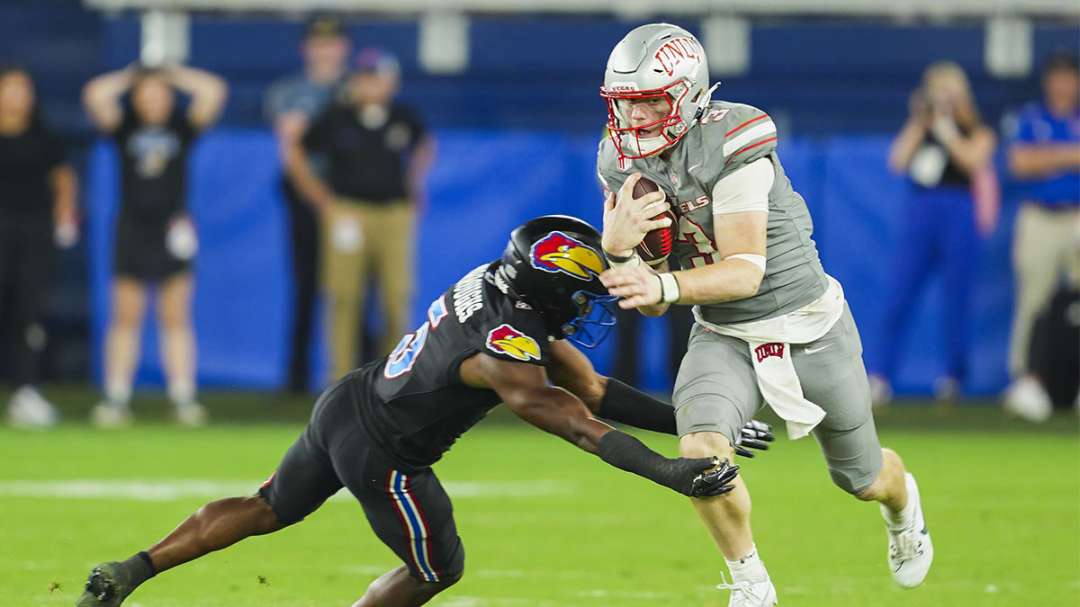 UNLV Rebels quarterback Matthew Sluka (3) runs the ball against Kansas Jayhawks safety O.J. Burroughs (5) during the second half at Children's Mercy Park.