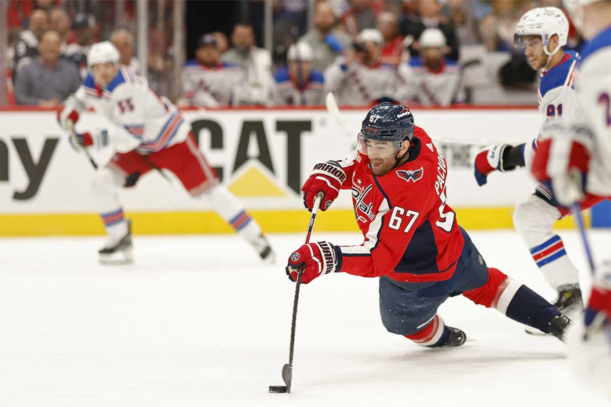 Washington Capitals left wing Max Pacioretty (67) shoots the puck while falling as New York Rangers center Alex Wennberg (91) looks on in the first period in game three of the first round of the 2024 Stanley Cup Playoffs at Capital One Arena.