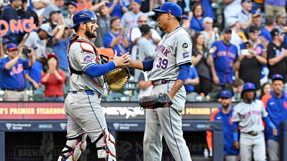 New York Mets outfielder Harrison Bader (44) and New York Mets pitcher Edwin Díaz (39) celebrate a 5-0 victory over the Milwaukee Brewers at American Family Field.