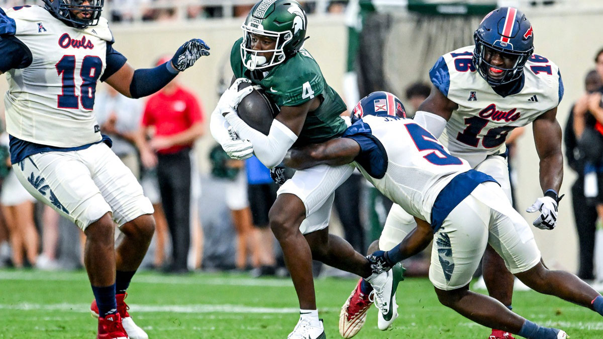 Michigan State's Jaron Glover, left, runs after a catch as Florida Atlantic's Jayden Williams closes in during the first quarter on Friday, Aug. 30, 2024, at Spartan Stadium in East Lansing.