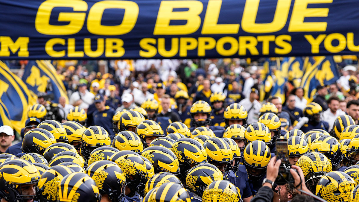 Michigan players huddle before kickoff against Texas at Michigan Stadium