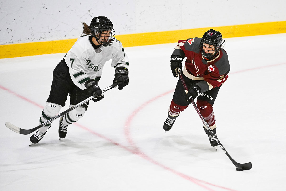 Montreal forward Ann-Sophie Bettez (24) plays the puck against Boston defender Sidney Morin (7) during overtime in a PWHL ice hockey game.