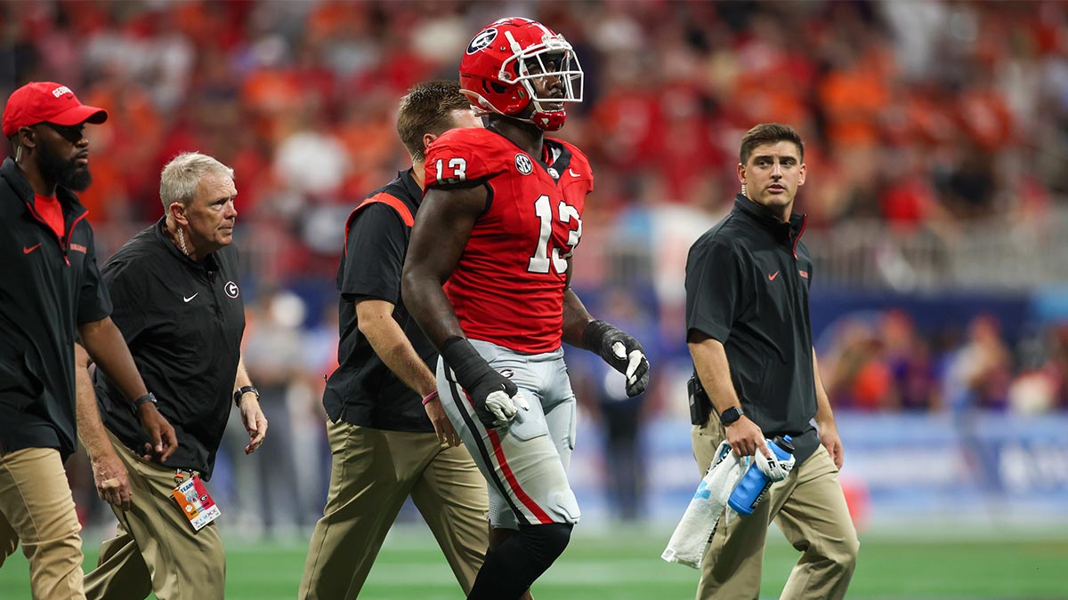 Georgia Bulldogs defensive lineman Mykel Williams (13) goes off the field with an injury against the Clemson Tigers in the third quarter at Mercedes-Benz Stadium.