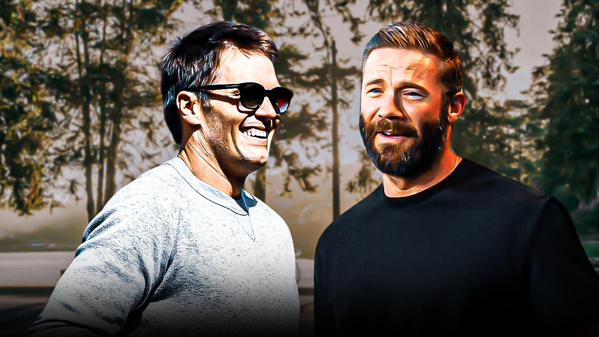 Julian Edelman in street clothes with heart eyes looking at Tom Brady in street clothes