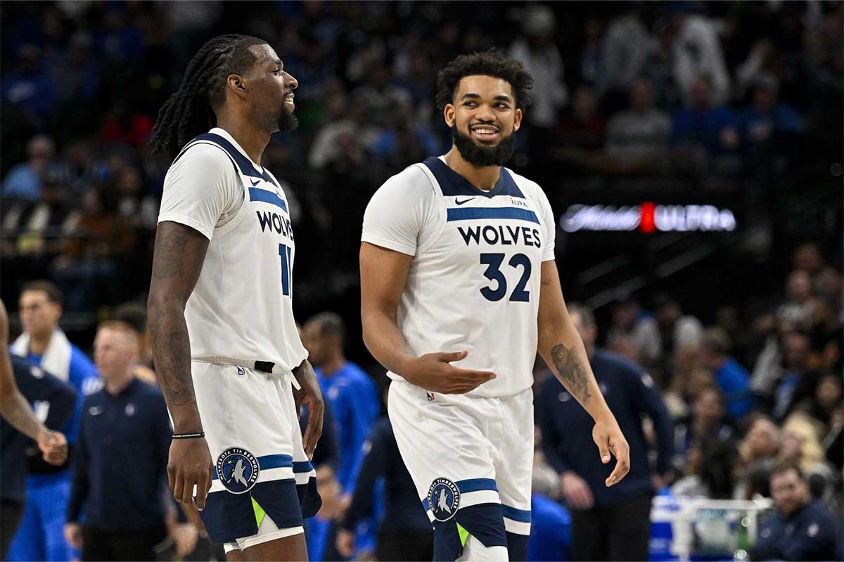 Minnesota Timberwolves center Naz Reid (11) and center Karl-Anthony Towns (32) walk off the court during the second half against the Dallas Mavericks at the American Airlines Center.