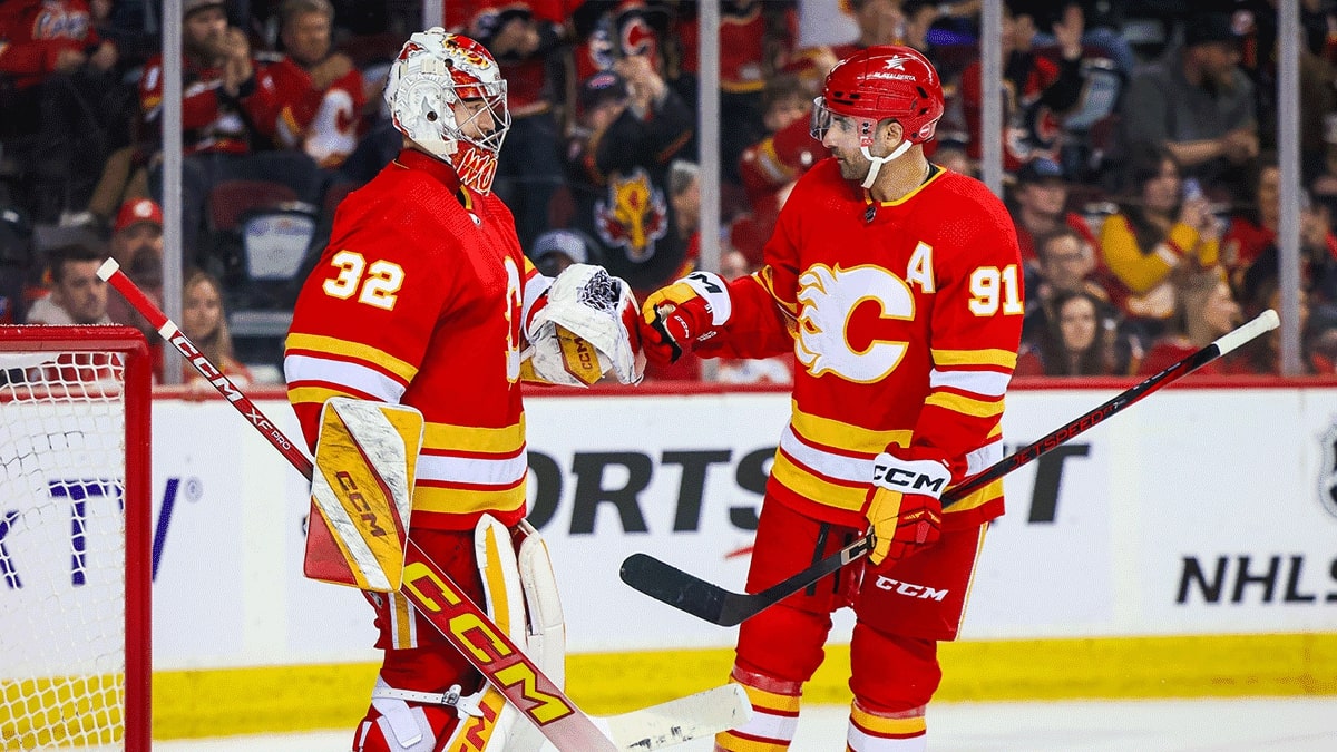 Calgary Flames goaltender Dustin Wolf (32) and center Nazem Kadri (91) celebrates win against San Jose Sharks at Scotiabank Saddledome.