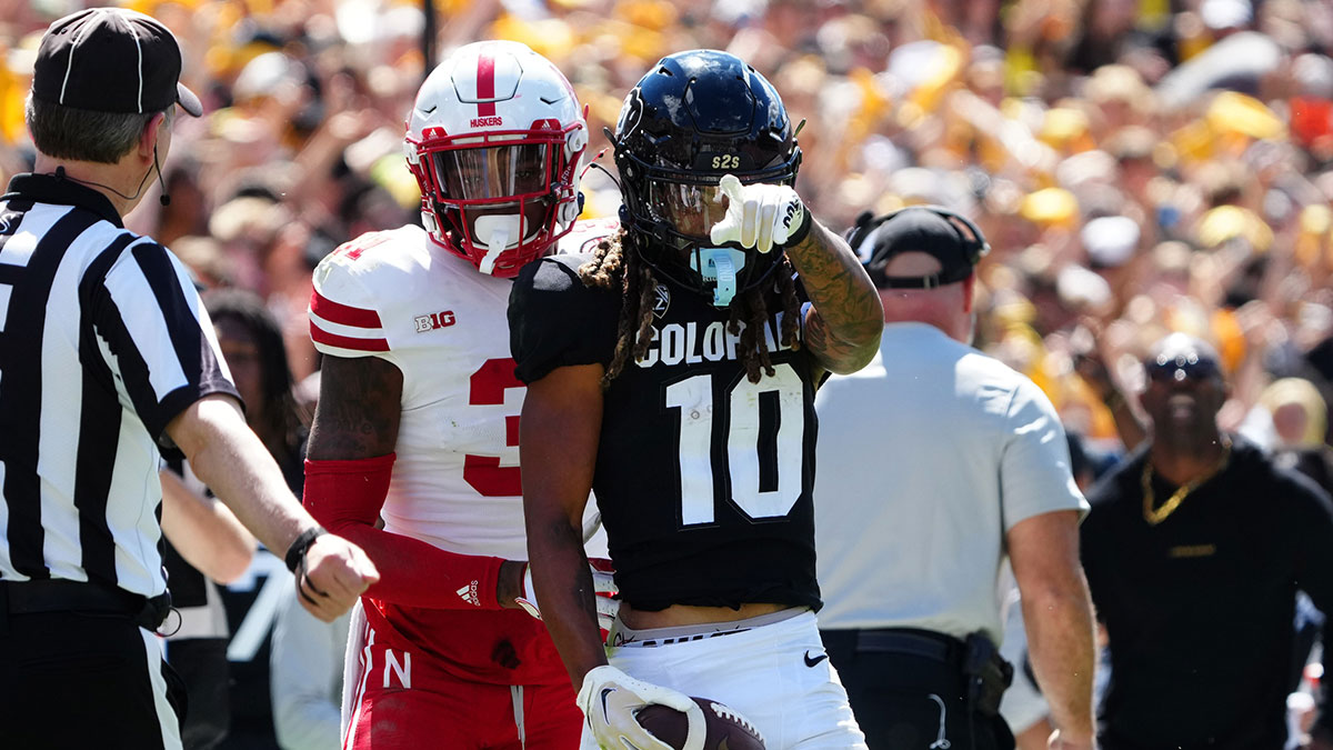 Colorado Buffaloes wide receiver Xavier Weaver (10) reacts to his first down reception catch next to Nebraska Cornhuskers linebacker Nick Henrich (3) during the third quarter at Folsom Field.