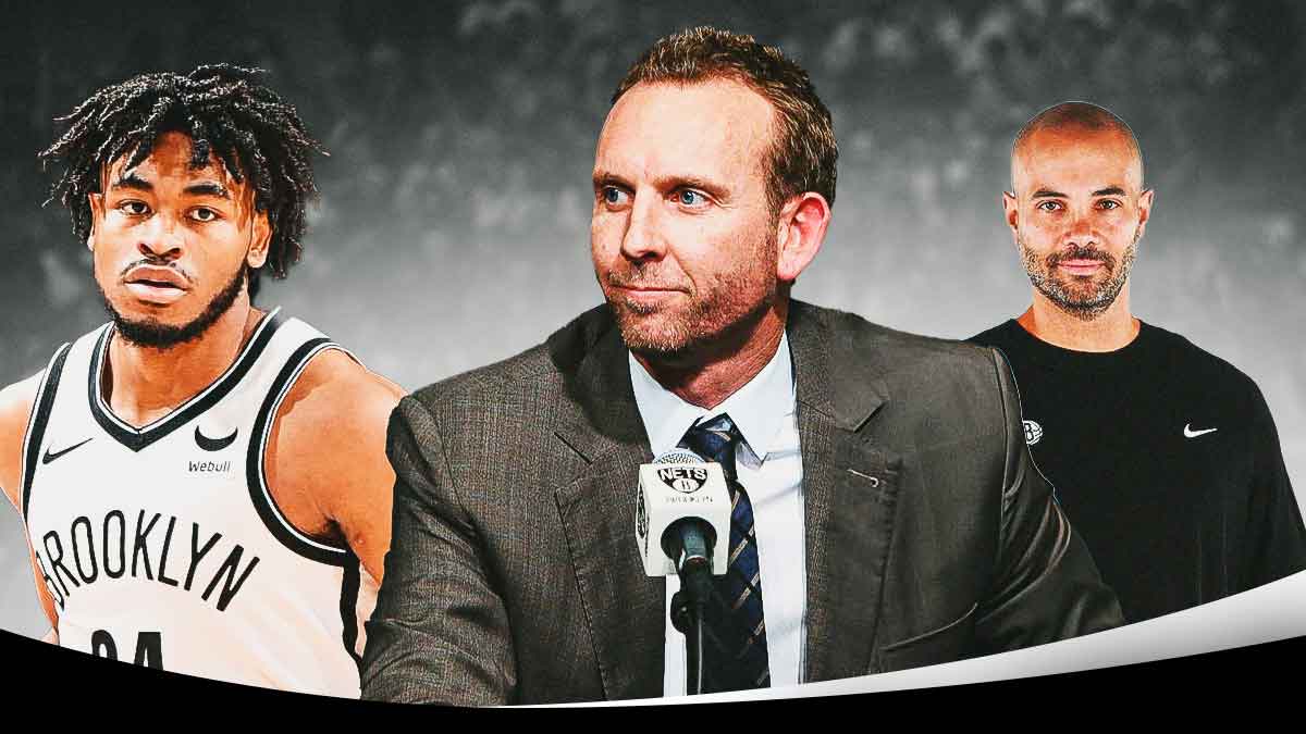 Nets' Cam Thomas on one side with Sean Marks and Jordi Fernandez on the other side looking at him