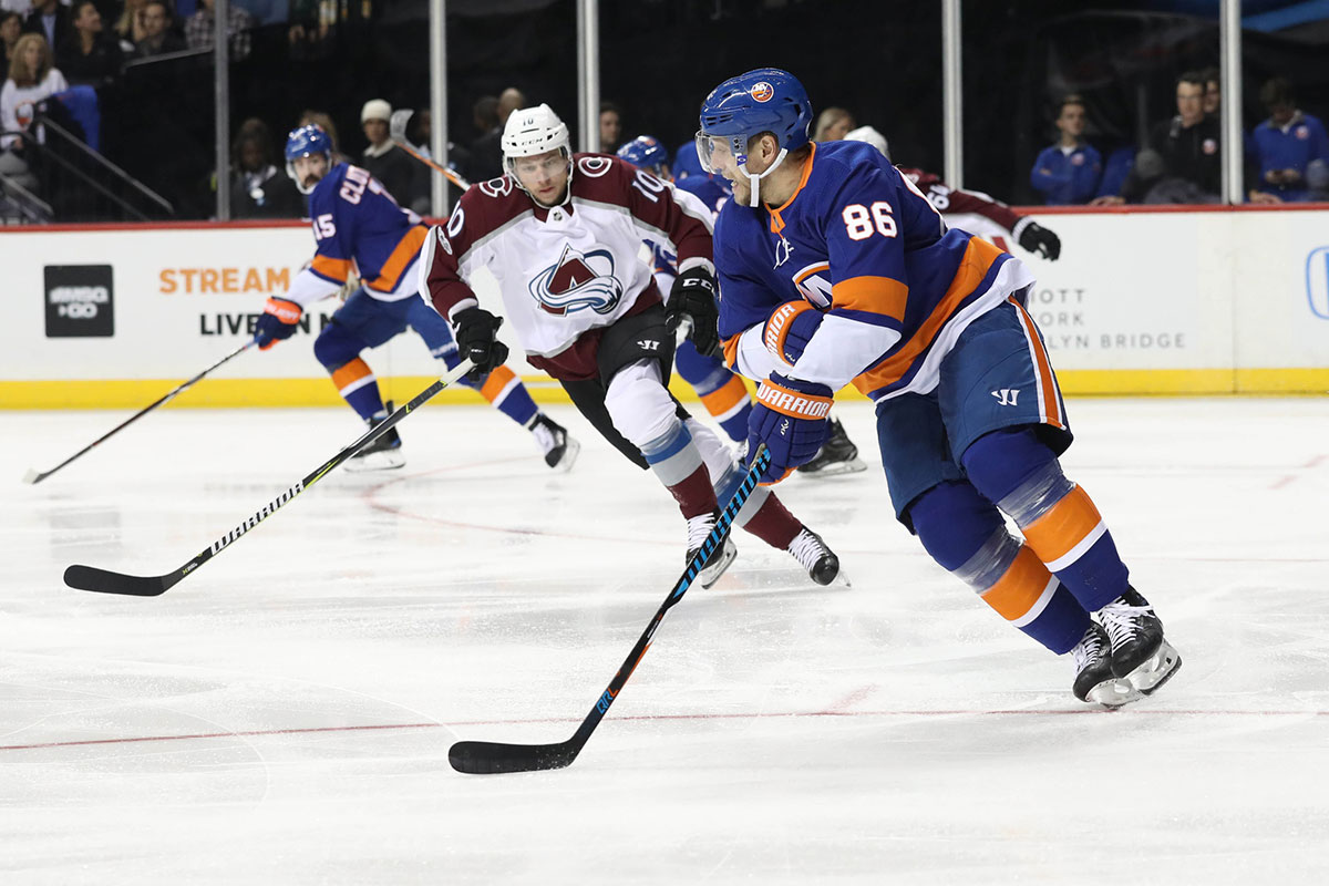 New York Islanders left wing Nikolay Kulemin (86) carries past Colorado Avalanche right wing Sven Andrighetto (10) during the first period at Barclays Center.