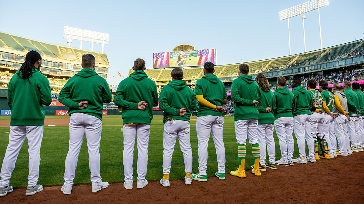 Oakland A’s players stand for the National Anthem before a game against the New York Yankees at Oakland-Alameda County Coliseum.