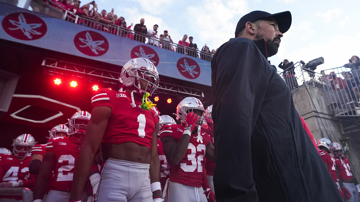 Ohio State Buckeyes cornerback Davison Igbinosun (1) and head coach Ryan Day prepare to take the field prior to a game against the Western Michigan Broncos at Ohio Stadium.