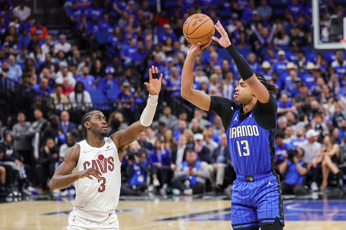 Apr 25, 2024; Orlando, Florida, USA; Orlando Magic guard Jett Howard (13) shoots a three point basket over Cleveland Cavaliers guard Caris LeVert (3) during the second half of game three of the first round for the 2024 NBA playoffs at Kia Center.