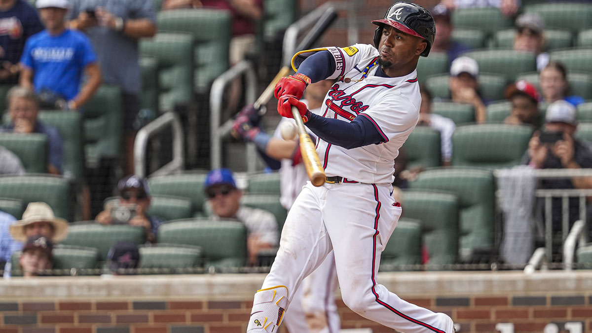 Jul 20, 2024; Cumberland, GA, USA; Atlanta Braves second baseman Ozzie Albies (1) hits a game winning sacrifice fly ball against the St. Louis Cardinals during the tenth inning at Truist Park. 