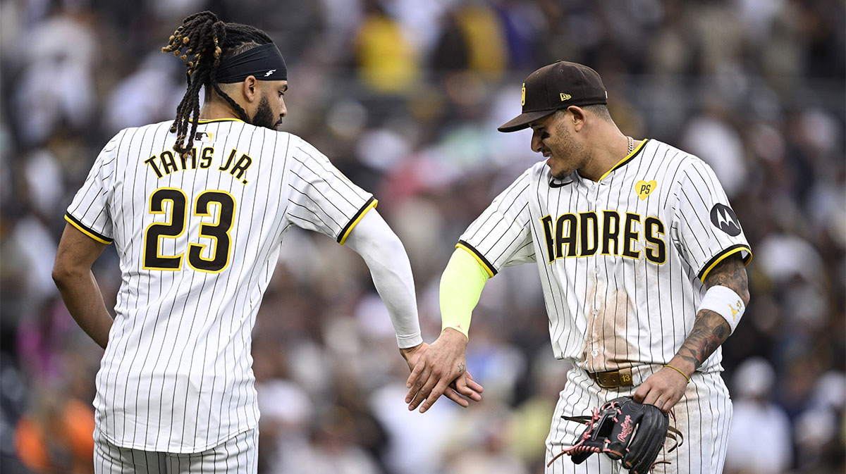 San Diego Padres third baseman Manny Machado (right) and designated hitter Fernando Tatis Jr. (23) celebrate on the field after defeating the Houston Astros at Petco Park.