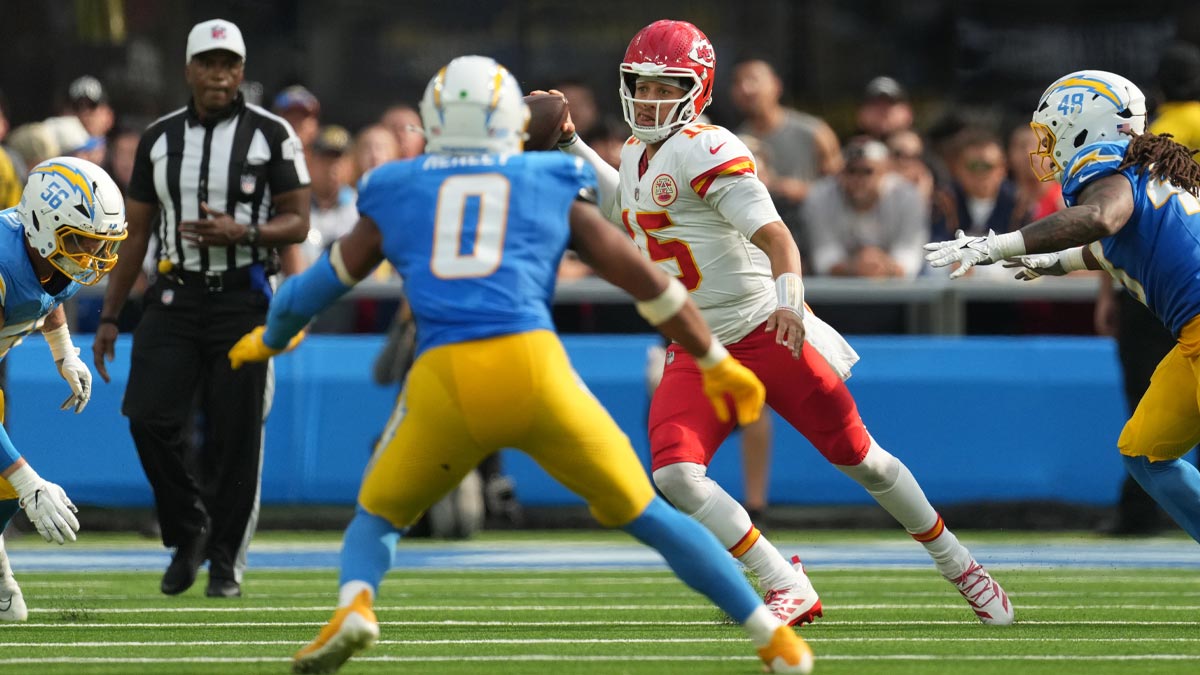 Kansas City Chiefs quarterback Patrick Mahomes (15) throws the ball against Los Angeles Chargers defensive end Morgan Fox (56), linebacker Daiyan Henley (0) and linebacker Bud Dupree (48) in the second half at SoFi Stadium.