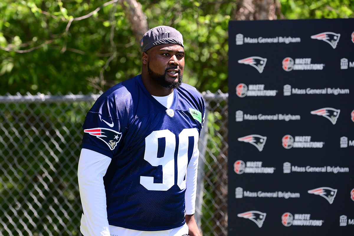 New England Patriots defensive tackle Christian Barmore (90) walks to the practice fields for minicamp at Gillette Stadium