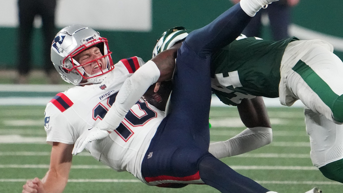 New England Patriots quarterback Drake Maye (10) gets sacked hard by New York Jets linebacker Jamien Sherwood (44) in the 4th quarter at MetLife Stadium.