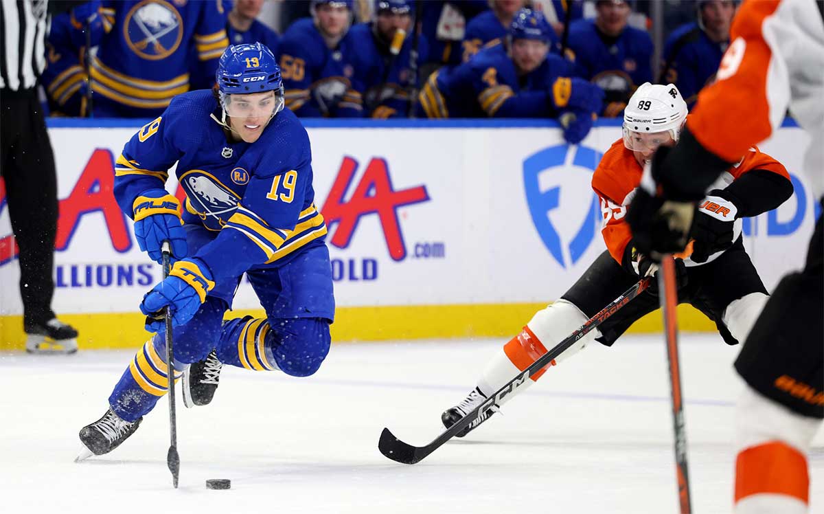 Sabres center Peyton Krebs controls the puck as Flyers right wing Cam Atkinson (89) defends.