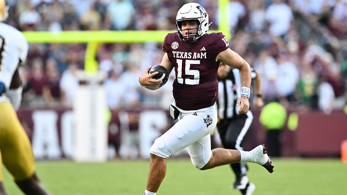 Texas A&M Aggies quarterback Conner Weigman (15) runs the ball during the first quarter against the Notre Dame Fighting Irish at Kyle Field.