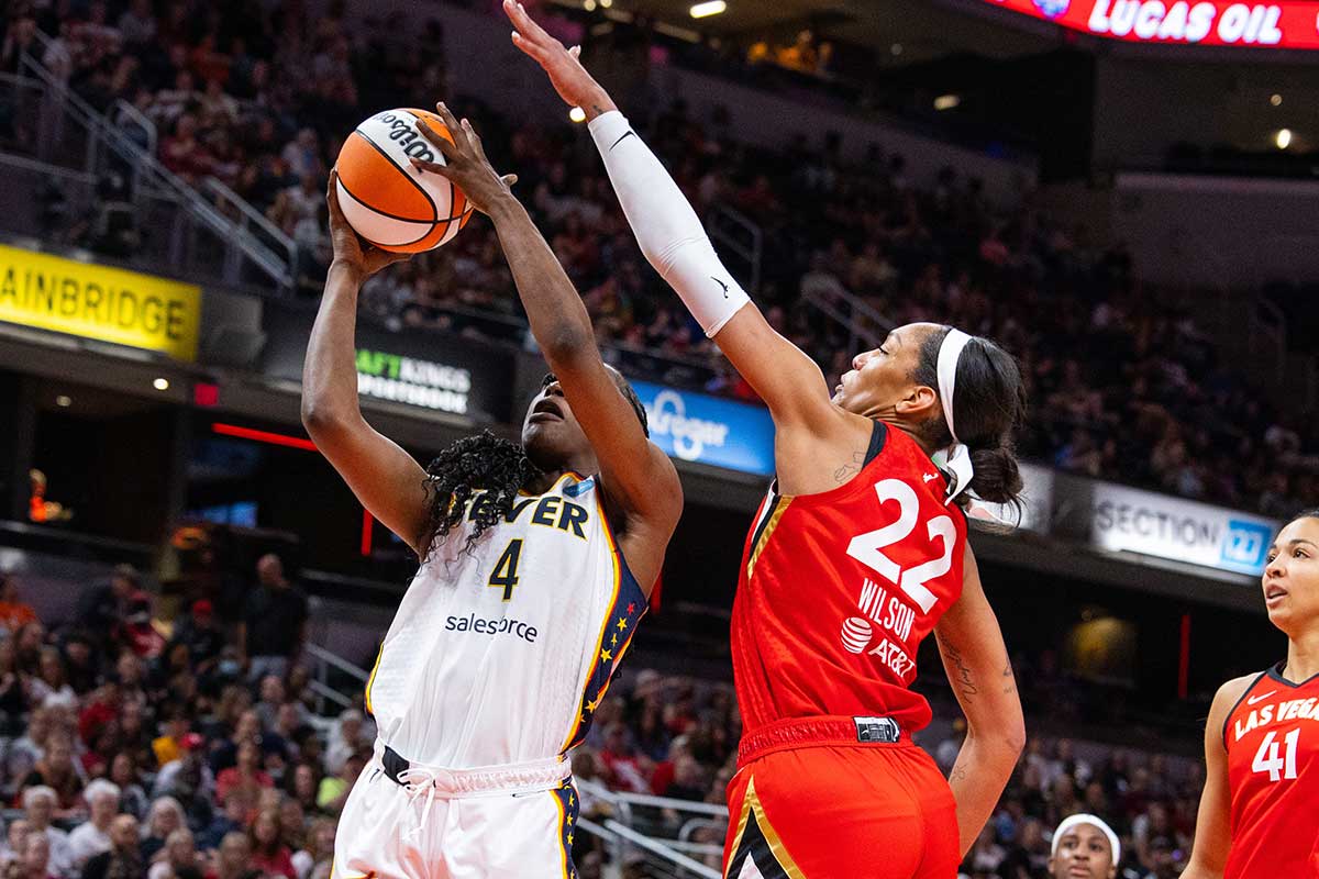 Indiana Fever center Queen Egbo (4) shoots the ball while Las Vegas Aces forward A'ja Wilson (22) defends in the first half at Gainbridge Fieldhouse.