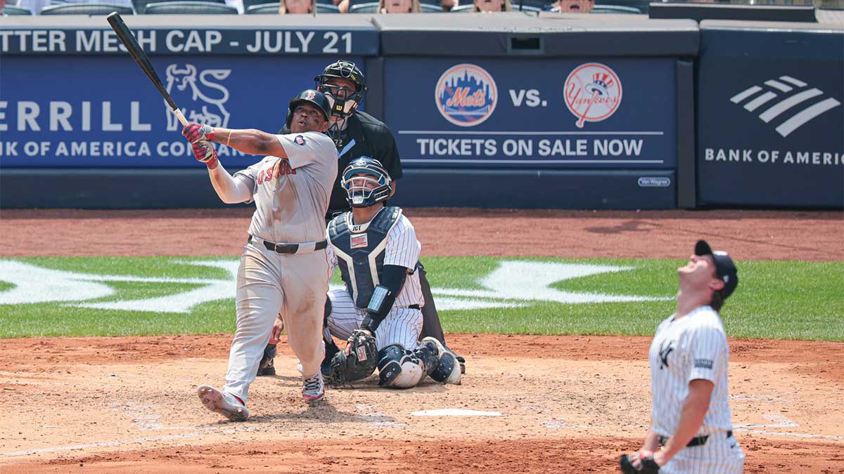 Boston Red Sox third baseman Rafael Devers (11) hits a solo home run during the fifth inning against New York Yankees starting pitcher Gerrit Cole (45) at Yankee Stadium.
