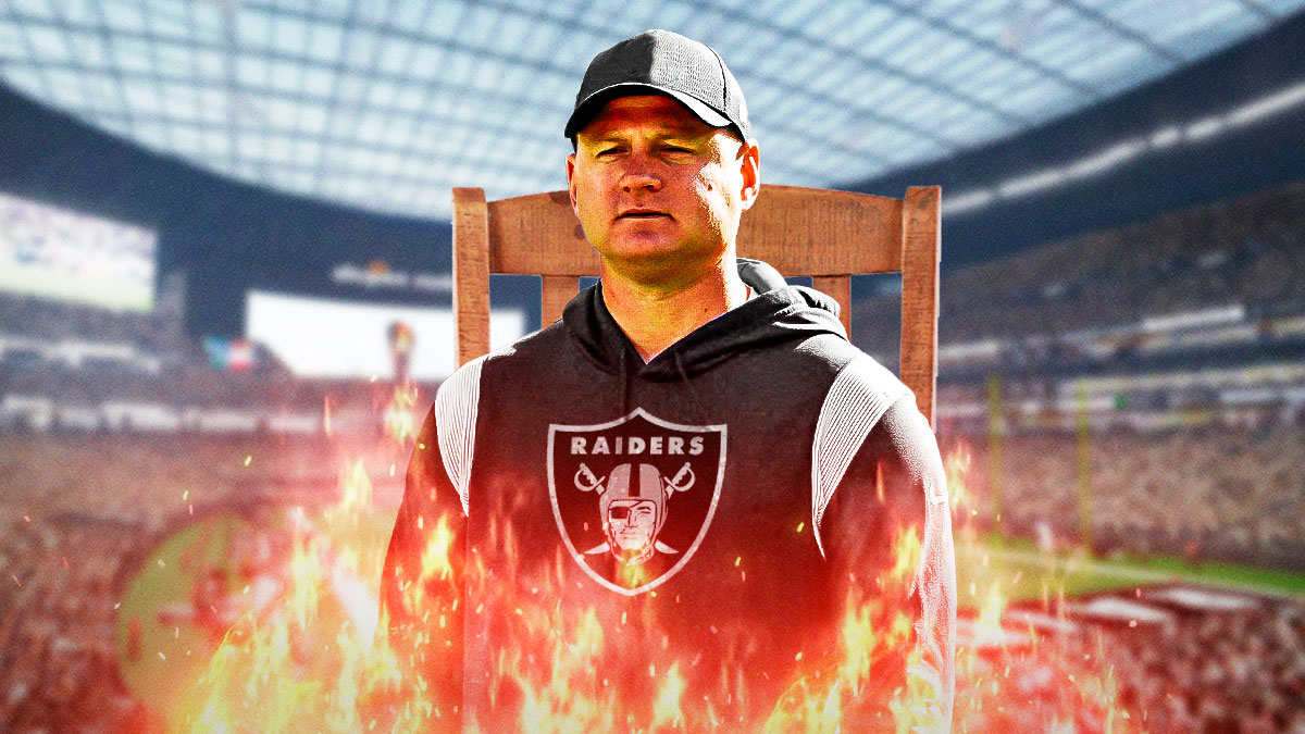 Luke Getsy in Raiders gear, in a chair that is on fire