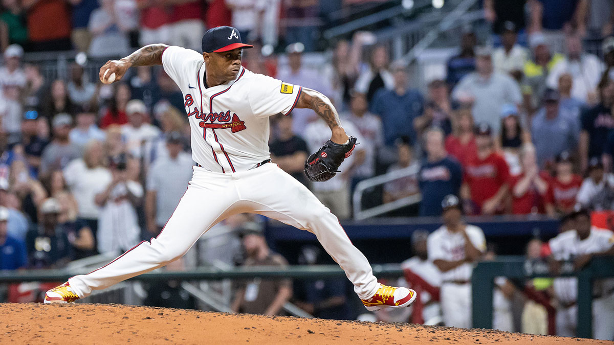 Aug 22, 2024; Cumberland, Georgia, USA; Atlanta Braves pitcher Raisel Iglesias (26) pitches the ball against Philadelphia Phillies during the ninth inning at Truist Park.