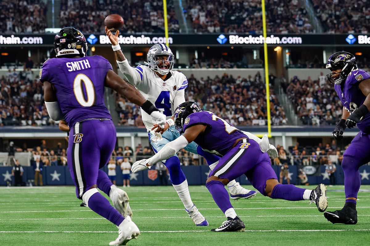 Dallas Cowboys quarterback Dak Prescott (4) is pressured on the 2 point attempt by Baltimore Ravens linebacker Trenton Simpson (23) during the fourth quarter at AT&T Stadium.