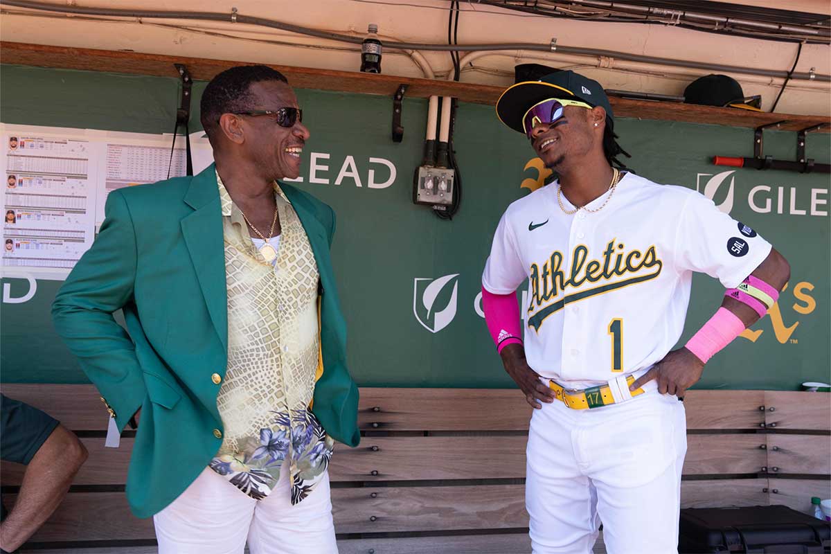 Retired baseball player Rickey Henderson smiles with Oakland Athletics center fielder Esteury Ruiz (1) before the start of the game against the San Francisco Giants at Oakland-Alameda County Coliseum.