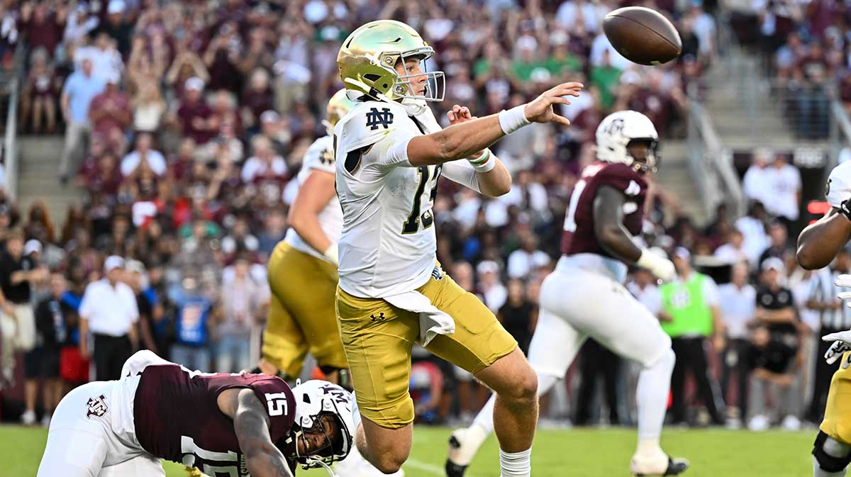 Notre Dame Fighting Irish quarterback Riley Leonard (13) throws a pass under pressure from Texas A&M Aggies quarterback Conner Weigman (15) during the first quarter at Kyle Field.