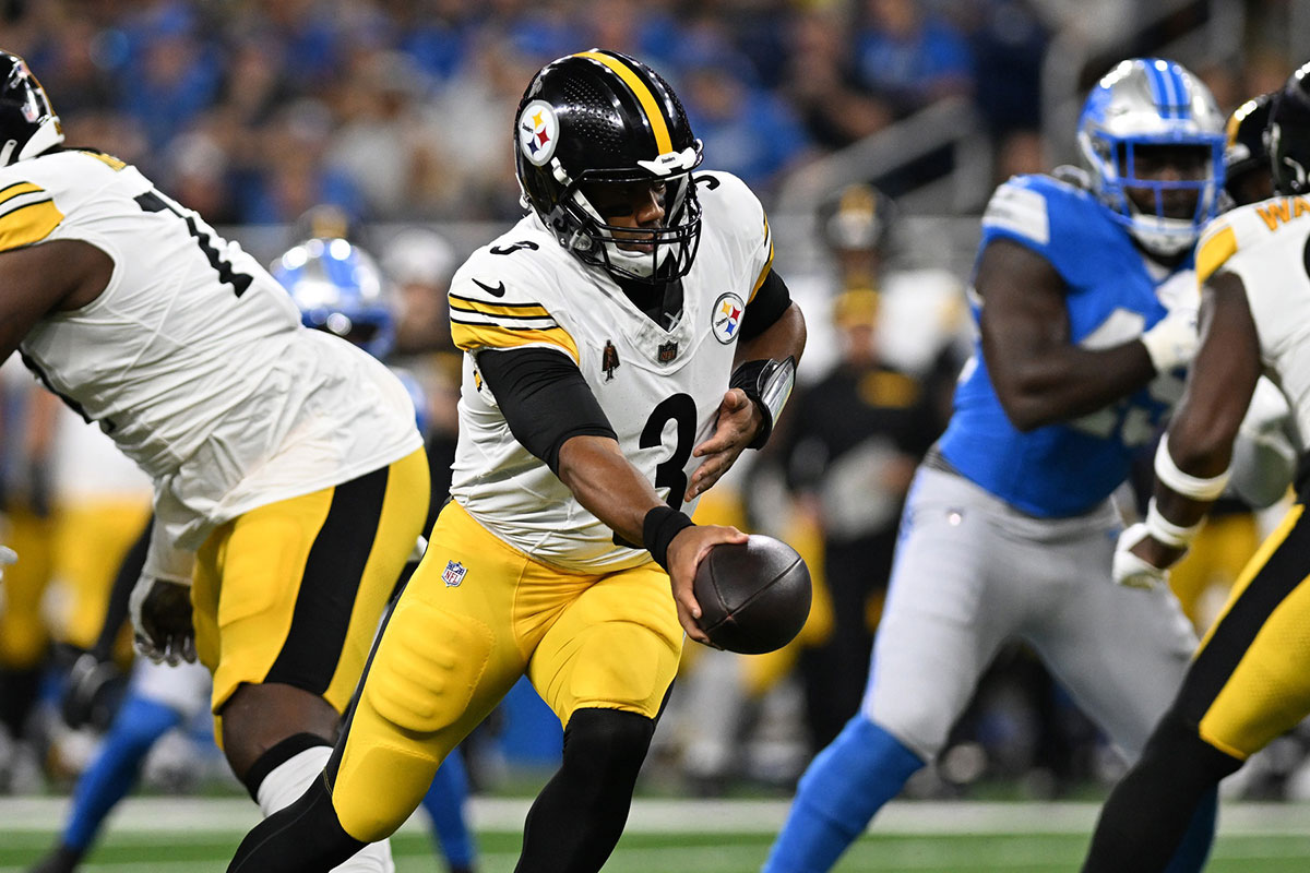 Pittsburgh Steelers quarterback Russell Wilson (3) hands the ball off against the Detroit Lions in the first quarter at Ford Field.