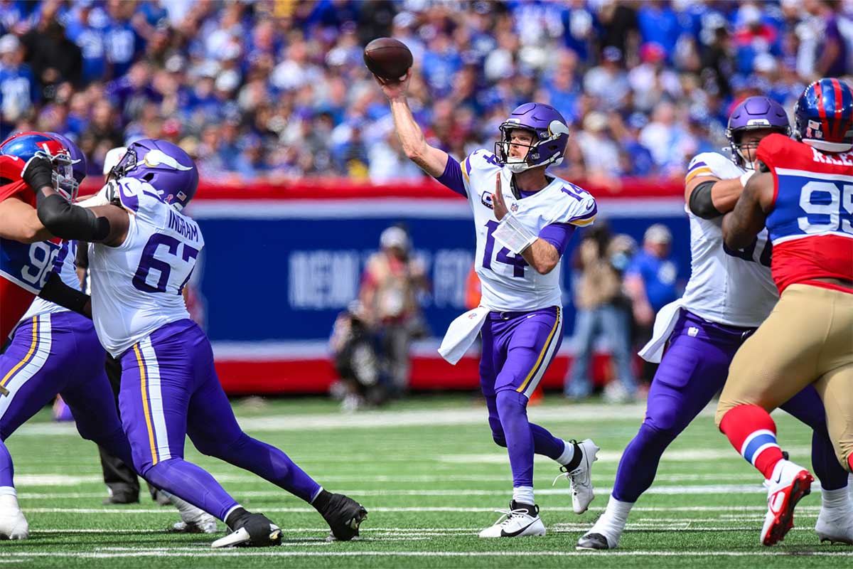 Minnesota Vikings quarterback Sam Darnold (14) throws a pass against the New York Giants during the first half at MetLife Stadium.