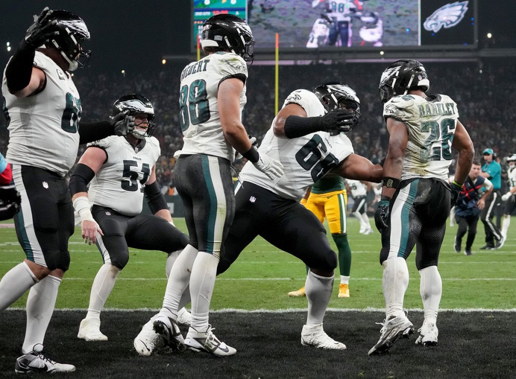 Philadelphia Eagles running back Saquon Barkley (26) celebrates with teammates after a touchdown during the second quarter against the Green Bay Packers at Neo Quimica Arena.