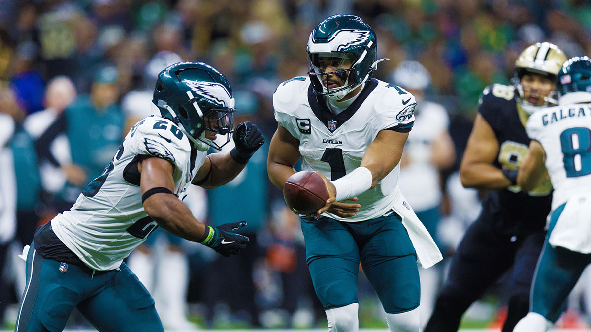Philadelphia Eagles quarterback Jalen Hurts (1) hands off to running back Saquon Barkley (26) against the New Orleans Saints during the second half at Caesars Superdome