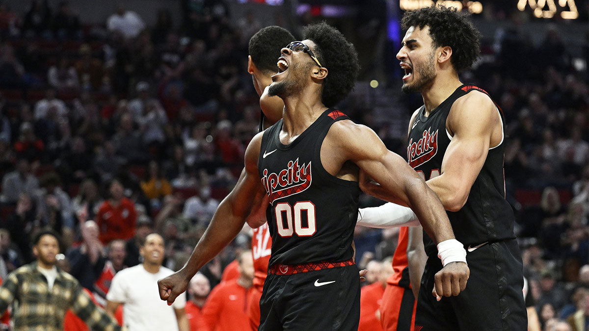 Portland Trail Blazers guard Scoot Henderson (00) reacts with teammate Justin Minaya (24) after dunking the basketball during the second half against the Houston Rockets at Moda Center. 