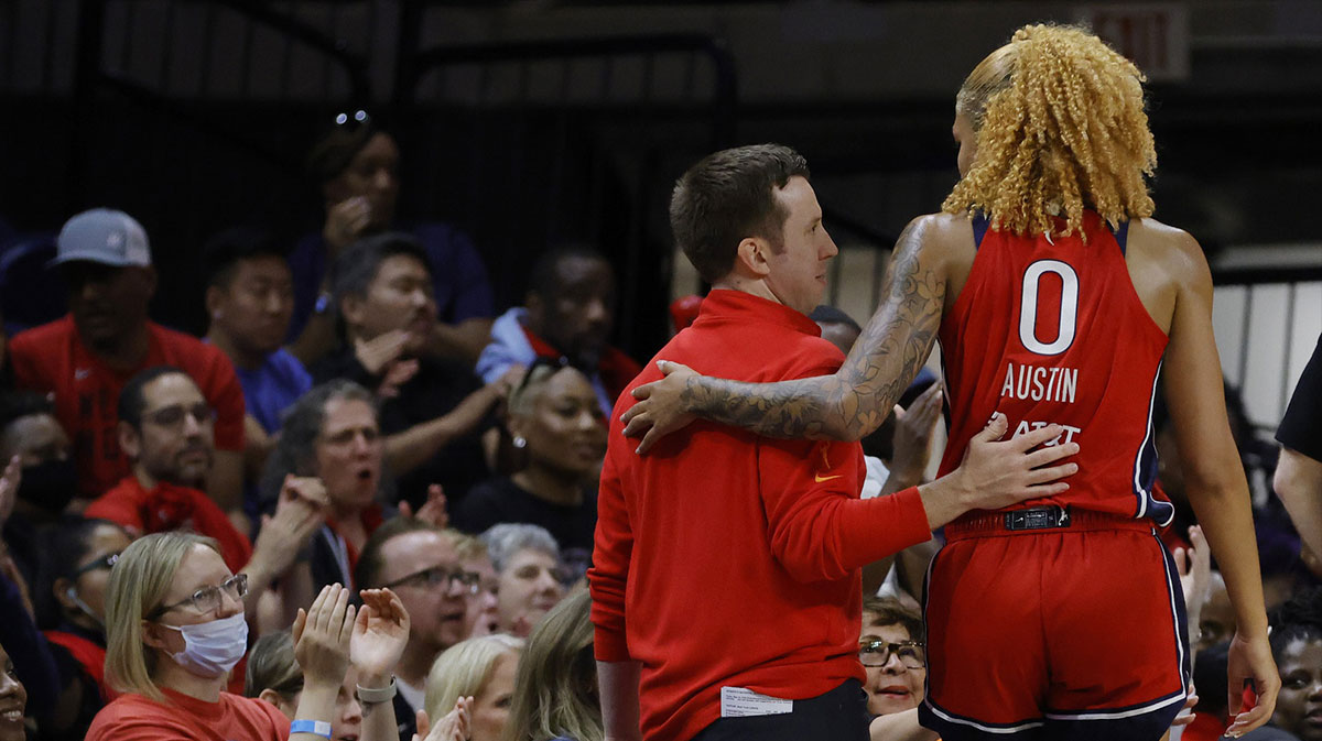 Washington Mystics head coach Eric Thibault (L) hugs Mystics center Shakira Austin (0) in the final minute against the New York Liberty in the fourth quarter.