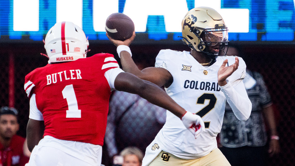 Colorado Buffaloes quarterback Shedeur Sanders (2) passes against Nebraska Cornhuskers defensive lineman Jimari Butler (1) during the first quarter at Memorial Stadium.
