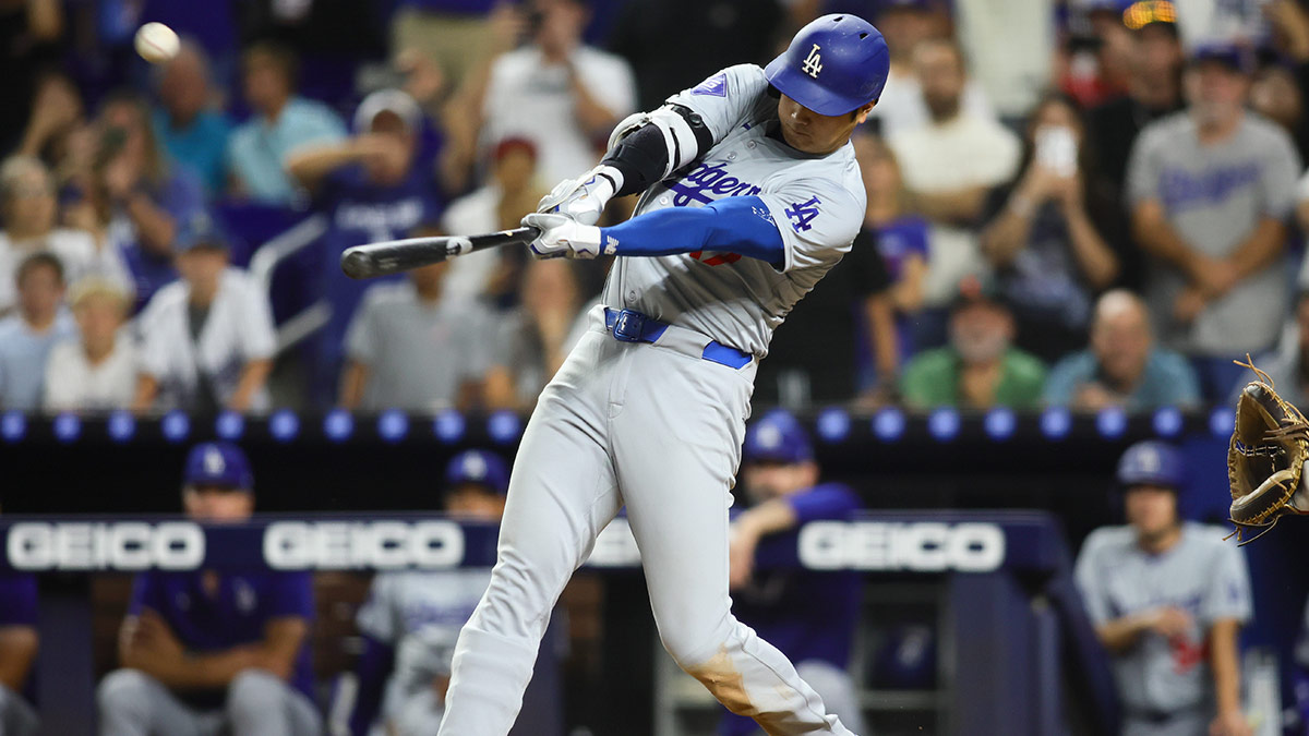 Los Angeles Dodgers designated hitter Shohei Ohtani (17) hits a three-run home run against the Miami Marlins during the ninth inning at loanDepot Park