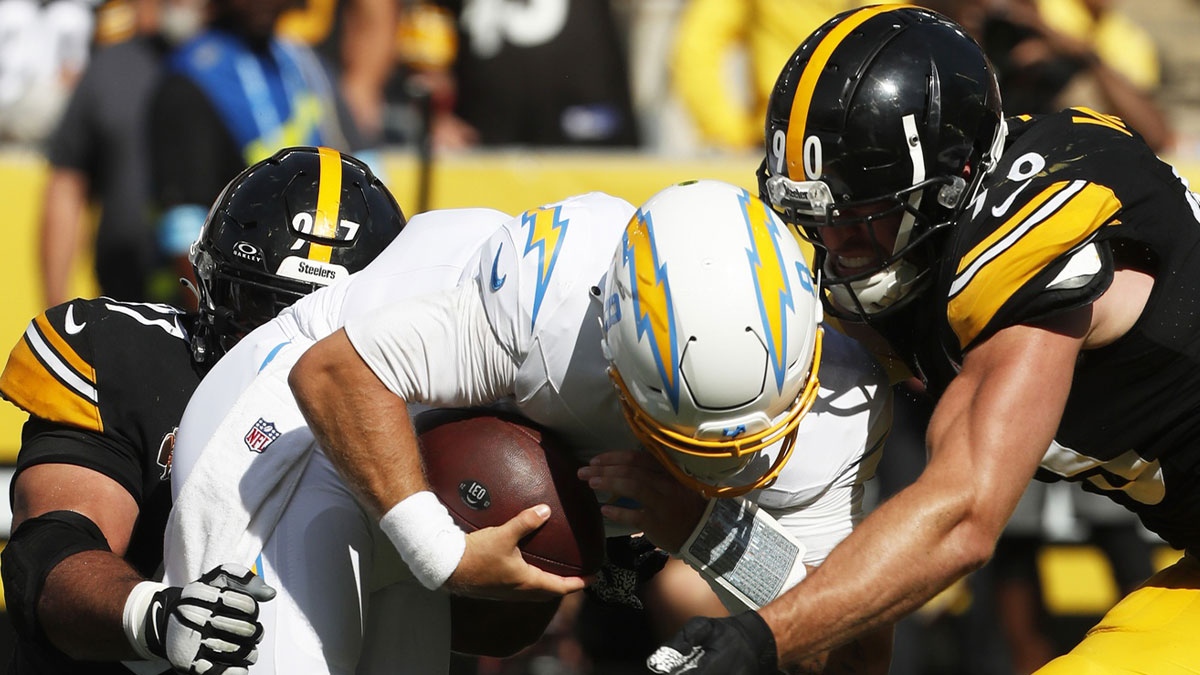 Pittsburgh Steelers defensive tackle Cameron Heyward (97) and linebacker T.J. Watt (90) sack Los Angeles Chargers quarterback Taylor Heinicke (8) during the fourth quarter at Acrisure Stadium. Pittsburgh won 20-10. 