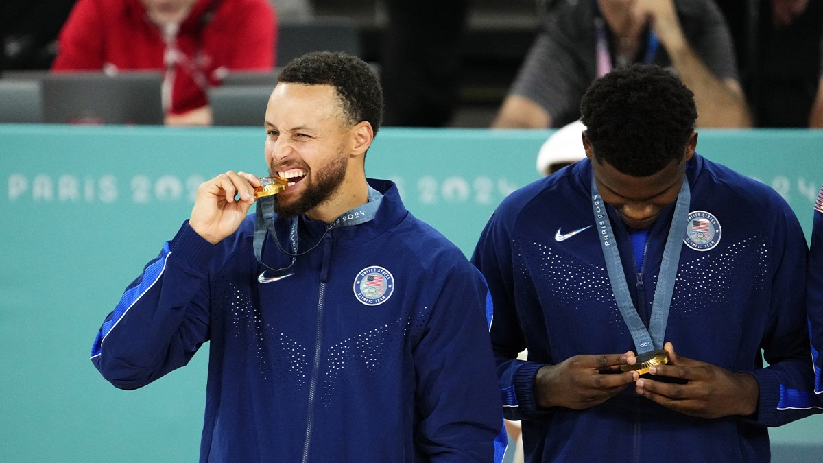 United States shooting guard Stephen Curry (4) celebrates with the gold medal after defeating France in the men's basketball gold medal game during the Paris 2024 Olympic Summer Games at Accor Arena.