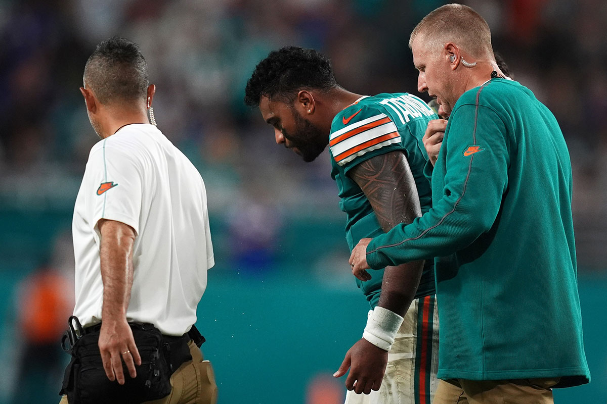 Miami Dolphins quarterback Tua Tagovailoa (1) walks off the field with training staff after an apparent injury during the second half against the Buffalo Bills at Hard Rock Stadium. 