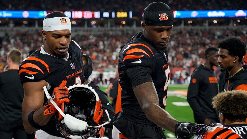 Cincinnati Bengals wide receiver Ja'Marr Chase (1) and wide receiver Tee Higgins (5) grab their helmets for a drive in the second quarter of the NFL Week 3 game between the Cincinnati Bengals and the Washington Commanders at Paycor Stadium in downtown Cincinnati on Monday, Sept. 23, 2024. The Commanders led 21-13 at halftime.